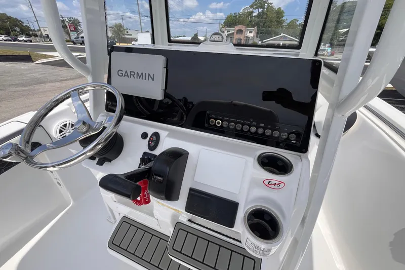 Slide: The Image of 2026 Tidewater 210 CC Adventure boat dashboard with Garmin navigation system and steering wheel. - 8