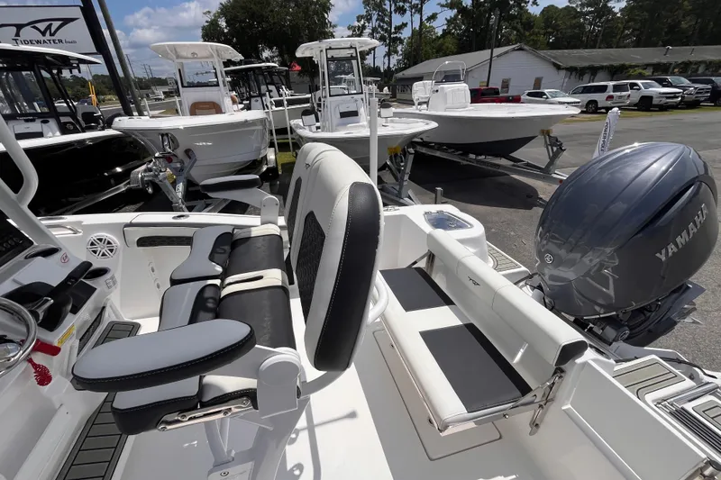 Slide: The Image of 2026 Tidewater 210 CC Adventure boat interior with Yamaha engine, showcasing seating and controls. - 14