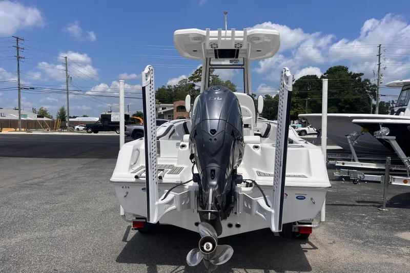 Slide: The Image of 2026 Tidewater 210 CC Adventure boat with powerful outboard motor, parked outdoors under blue sky. - 3