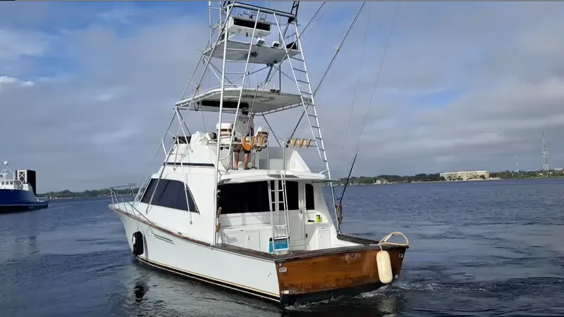 Slide: The Image of A 1988 Ocean Yachts 48 Super Sport cruising on calm waters, featuring a tall flybridge. - 3
