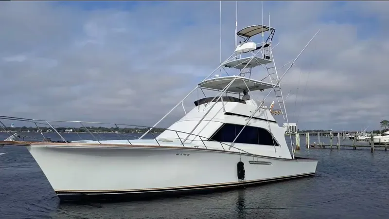 The Image of A 1988 Ocean Yachts 48 Super Sport is on the water, featuring a distinctive multi-level design. - 0