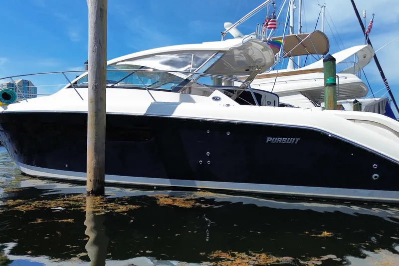 Slide: The Image of 2014 Pursuit SC 365i Sport Coupe docked in marina, sleek design, sunny day. - 68
