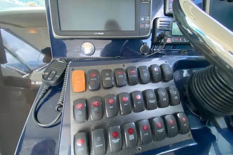 Slide: The Image of Control panel of a 2014 Pursuit SC 365i Sport Coupe boat with various switches. - 35