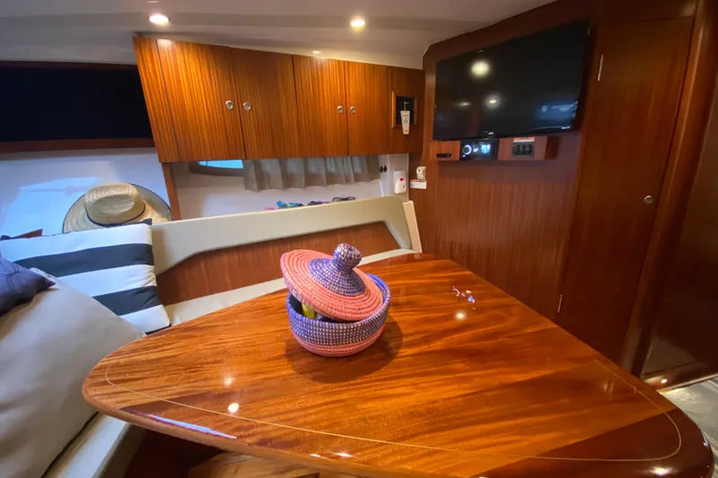 Slide: The Image of Luxurious interior of 2014 Pursuit SC 365i Sport Coupe with wooden table and modern amenities. - 48