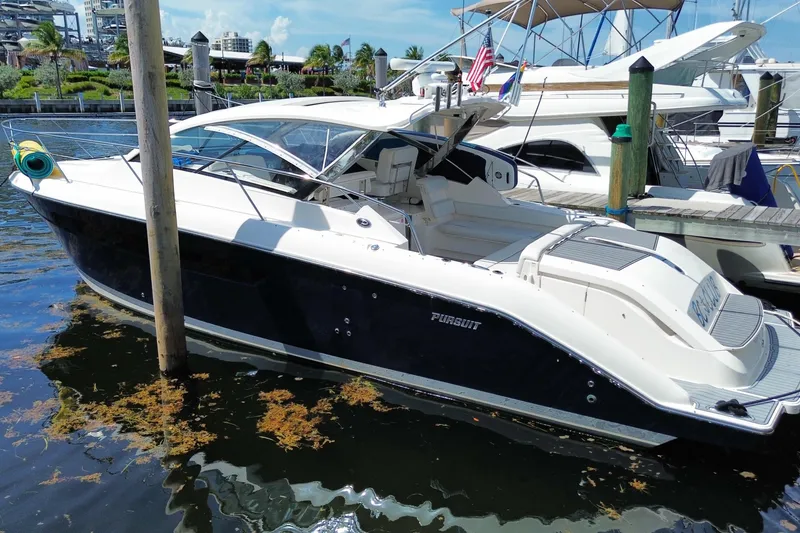 Slide: The Image of 2014 Pursuit SC 365i Sport Coupe docked at marina, sleek design, sunny day. - 67