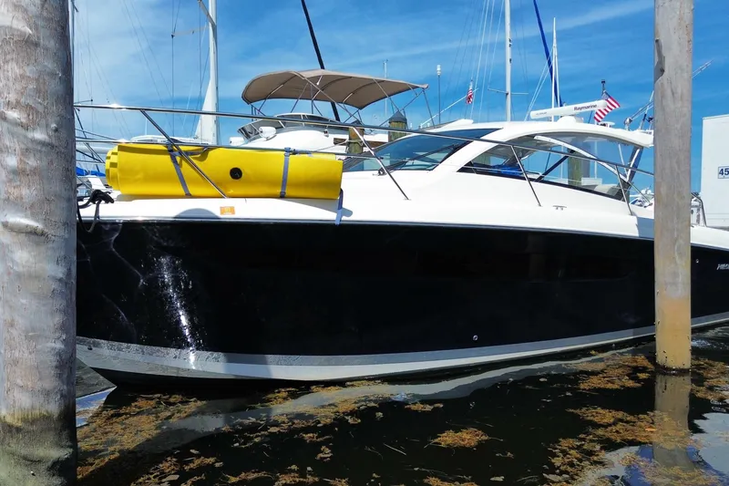 Slide: The Image of 2014 Pursuit SC 365i Sport Coupe docked, featuring sleek design and vibrant yellow equipment. - 71
