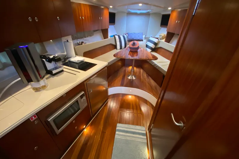 Slide: The Image of Luxurious interior of 2014 Pursuit SC 365i Sport Coupe with wood finishes and modern amenities. - 46