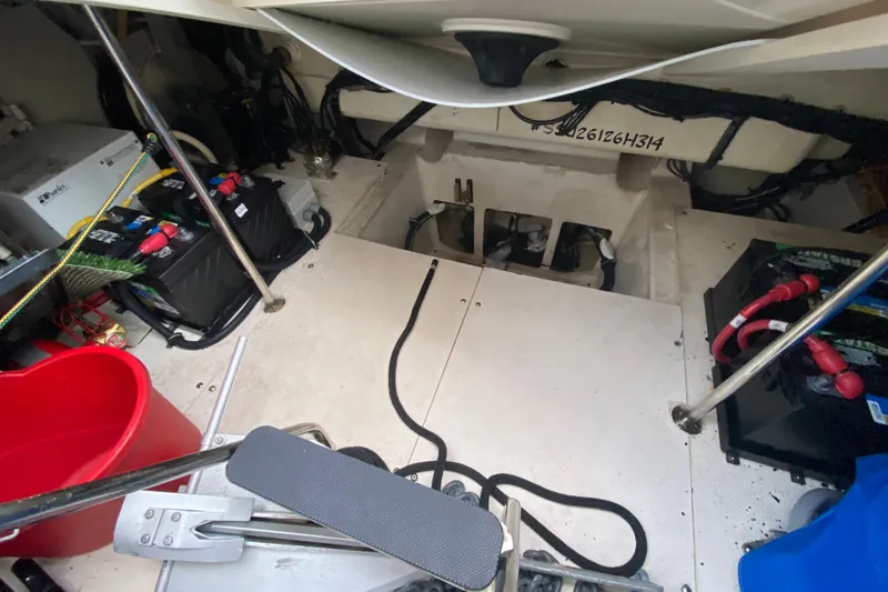 Slide: The Image of Engine compartment of a 2014 Pursuit SC 365i Sport Coupe with visible batteries and wiring. - 58