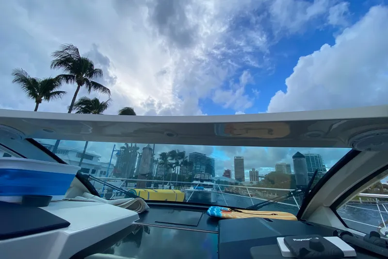Slide: The Image of 2014 Pursuit SC 365i Sport Coupe interior with city skyline and palm trees. - 37