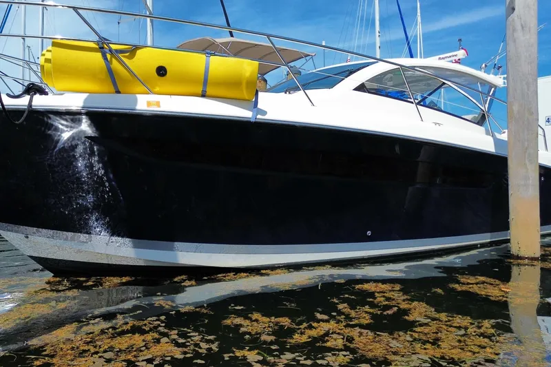 Slide: The Image of 2014 Pursuit SC 365i Sport Coupe docked, featuring sleek design and vibrant yellow equipment. - 66