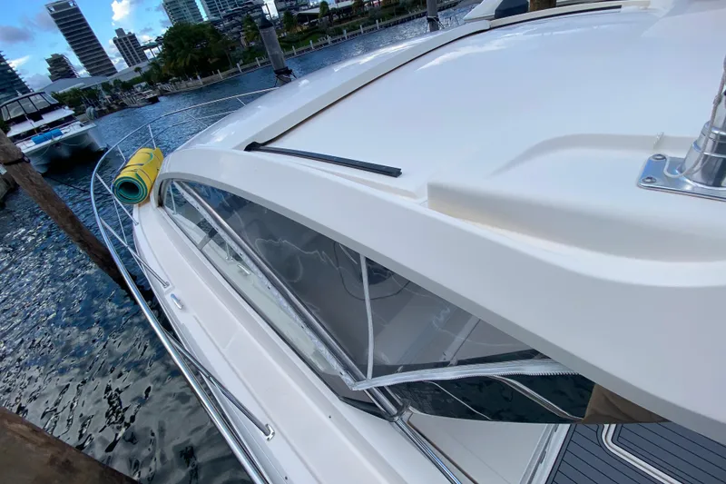 Slide: The Image of 2014 Pursuit SC 365i Sport Coupe docked at marina, city skyline in background. - 22