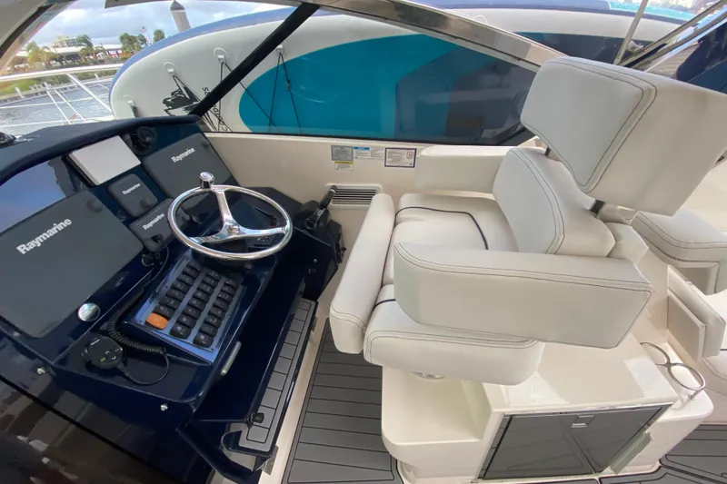 Slide: The Image of 2014 Pursuit SC 365i Sport Coupe helm with Raymarine electronics and plush seating. - 31
