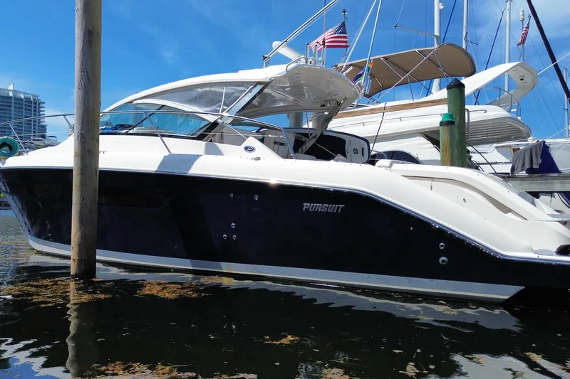 Slide: The Image of 2014 Pursuit SC 365i Sport Coupe docked at marina, sleek design, sunny day. - 65