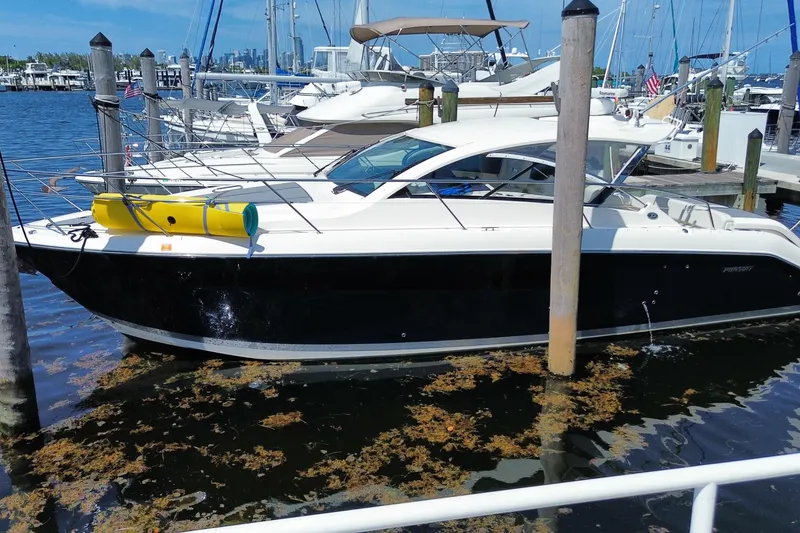 Slide: The Image of 2014 Pursuit SC 365i Sport Coupe docked at marina, surrounded by boats. - 72