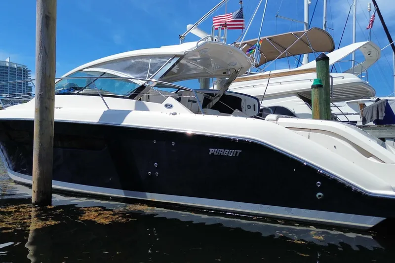 Slide: The Image of 2014 Pursuit SC 365i Sport Coupe docked at marina under clear blue sky. - 7