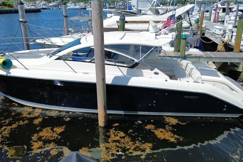 Slide: The Image of 2014 Pursuit SC 365i Sport Coupe docked at marina, side view. - 11