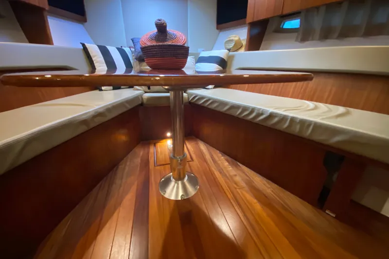 Slide: The Image of Interior of 2014 Pursuit SC 365i Sport Coupe with wooden table and cushioned seating. - 52