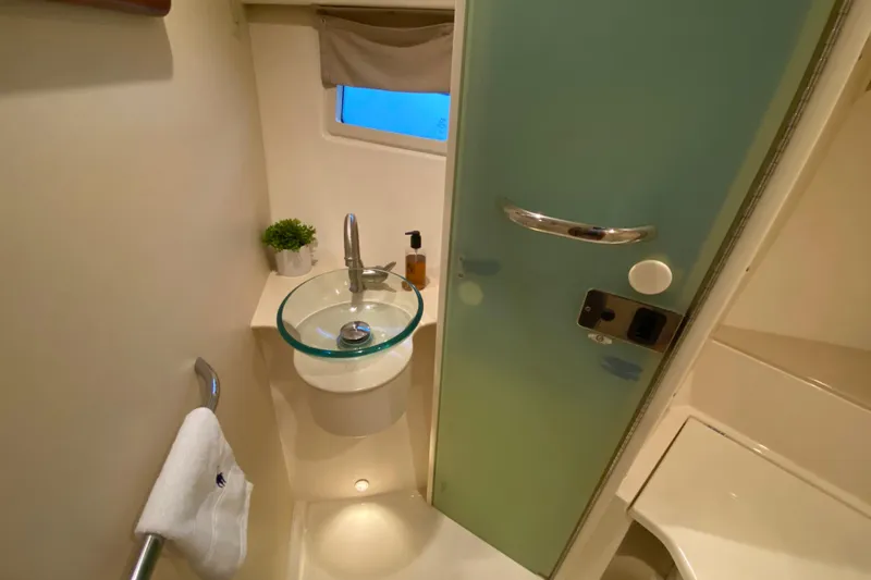 Slide: The Image of 2014 Pursuit SC 365i Sport Coupe bathroom with glass sink and modern fixtures. - 57