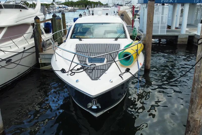 Slide: The Image of 2014 Pursuit SC 365i Sport Coupe docked at marina, front view with nautical equipment. - 17