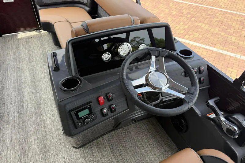 Slide: The Image of 2026 Bennington 21 SLJ boat dashboard with steering wheel, gauges, and controls. - 12