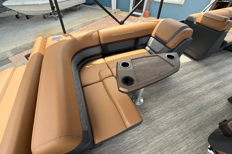 Slide: The Image of Luxurious seating area on a 2026 Bennington 21 SLJ pontoon boat with cupholders and table. - 9