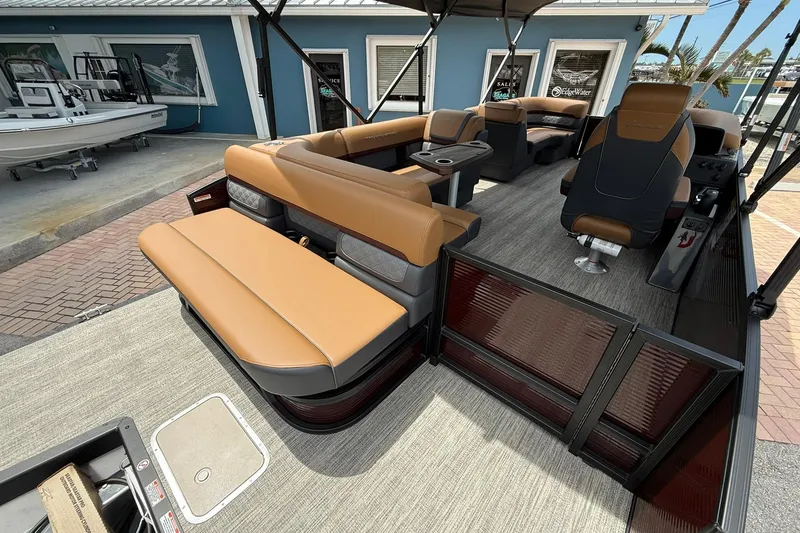 Slide: The Image of 2026 Bennington 21 SLJ pontoon boat interior with tan seating and modern design. - 6