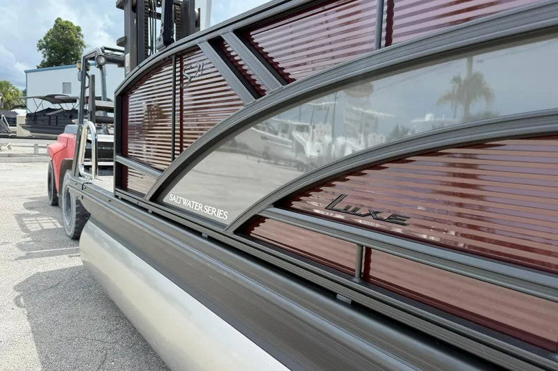 Slide: The Image of 2026 Bennington 21 SLJ Saltwater Series Luxe pontoon boat, side view in marina setting. - 3