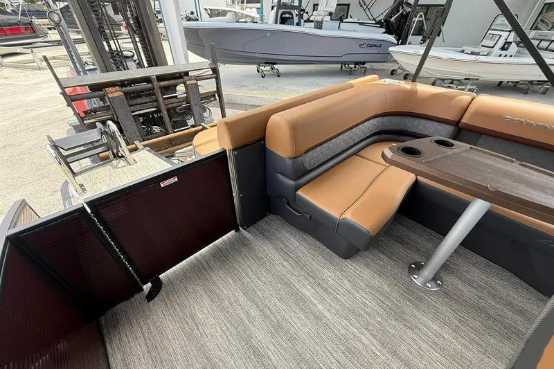 Slide: The Image of Interior of 2026 Bennington 21 SLJ pontoon boat with tan seating and table. - 8