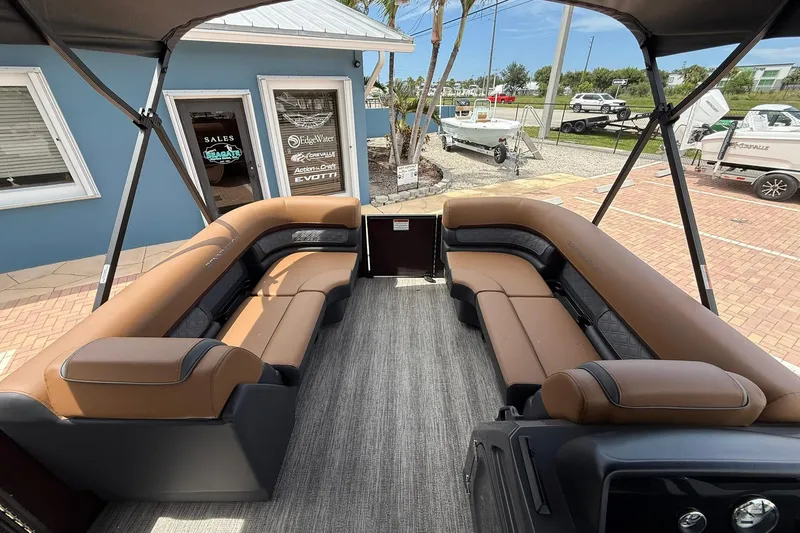 Slide: The Image of Interior of 2026 Bennington 21 SLJ pontoon boat with brown seating and canopy. - 16