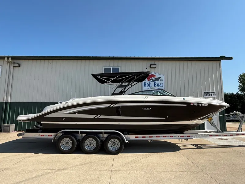 Slide: The Image of 2017 Sea Ray SDX 290 on a trailer parked in front of a building. - 36
