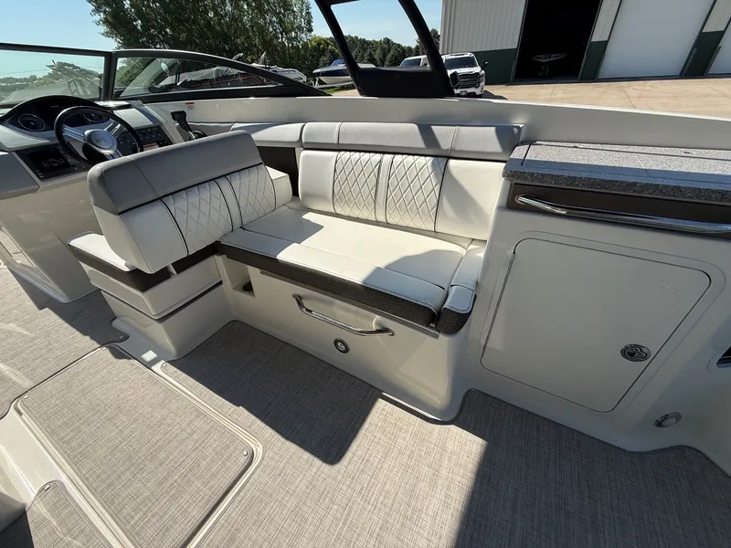 Slide: The Image of The image shows the cockpit of a 2017 Sea Ray SDX 290 with sleek seating and controls. - 27