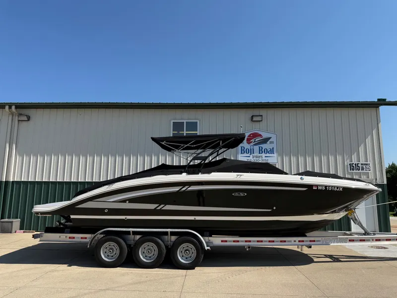 Slide: The Image of A 2017 Sea Ray SDX 290 boat on a trailer in front of a building. - 35