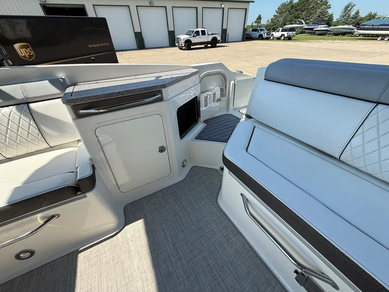 Slide: The Image of The image shows the cockpit of a 2017 Sea Ray SDX 290 with sleek seating and storage. - 26