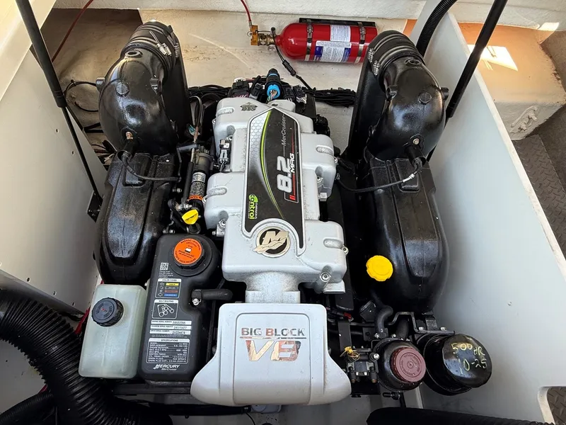 Slide: The Image of The engine compartment of a 2017 Sea Ray SDX 290 features a powerful engine with tidy wiring. - 34