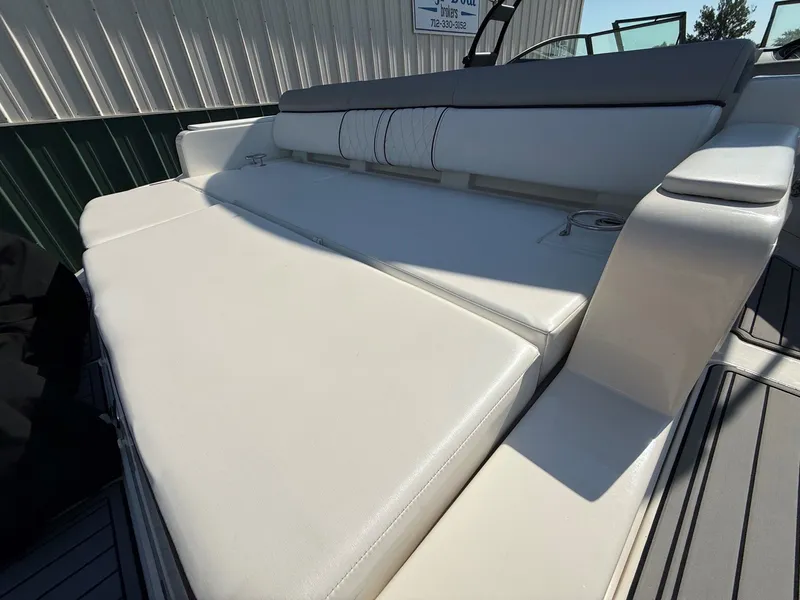 Slide: The Image of The 2017 Sea Ray SDX 290 features a spacious, cushioned sun deck with comfortable seating. - 9