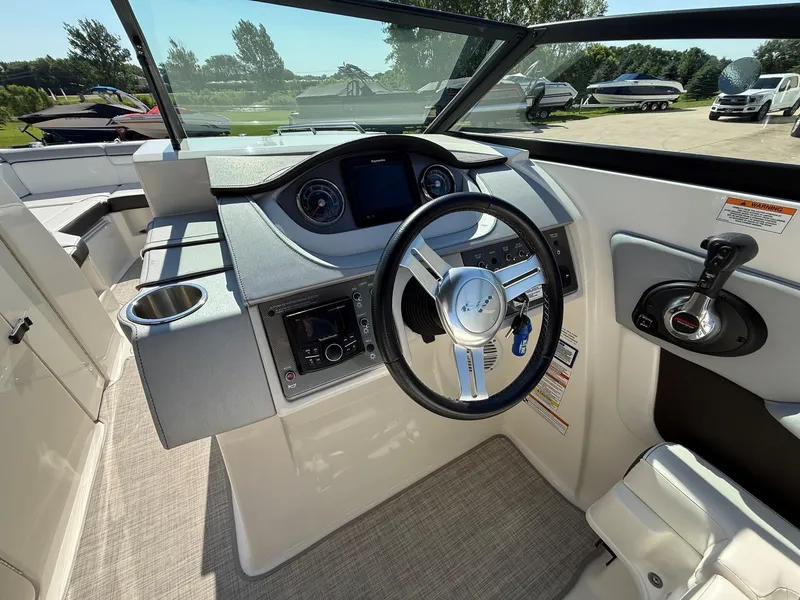 Slide: The Image of The image shows the helm of a 2017 Sea Ray SDX 290 boat. - 18