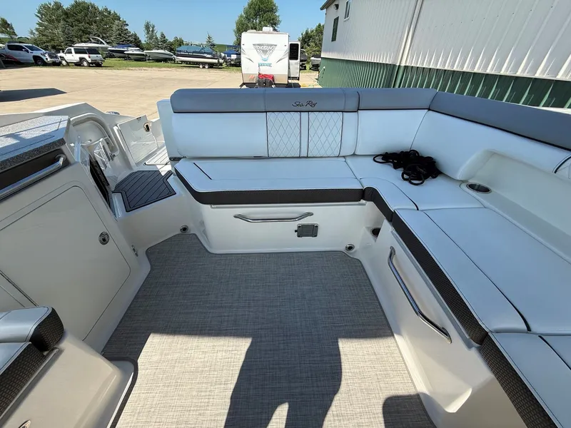 Slide: The Image of The image shows the cockpit of a 2017 Sea Ray SDX 290 boat with white upholstery. - 25