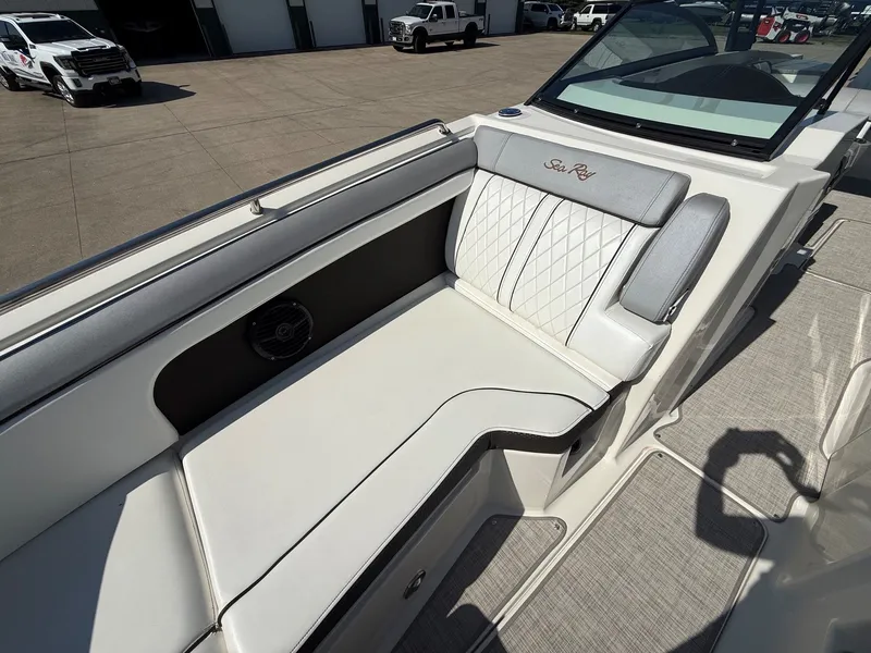 Slide: The Image of The image shows the seating area of a 2017 Sea Ray SDX 290 boat with elegant upholstery. - 12
