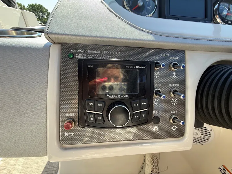 Slide: The Image of The image shows the dashboard of a Sea Ray SDX 290 boat with a Rockford Fosgate audio system. - 31