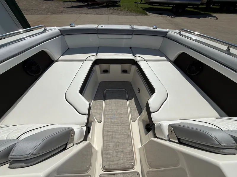 Slide: The Image of The image shows the bow area of a 2017 Sea Ray SDX 290 boat with white upholstery. - 10