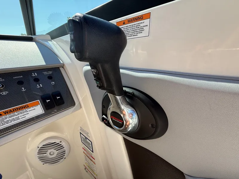 Slide: The Image of Close-up of the throttle lever on a 2017 Sea Ray SDX 290 with warning labels. - 19