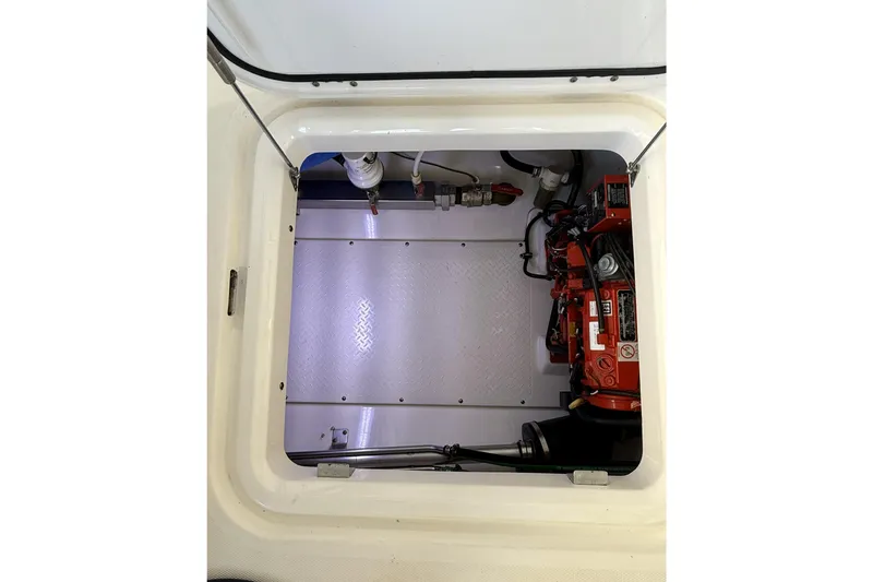 Slide: The Image of Engine compartment of a 2012 Everglades 350LX boat, showcasing mechanical components. - 83