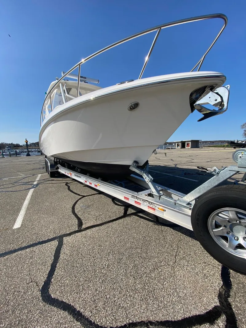 Slide: The Image of 2012 Everglades 350LX boat on trailer in parking lot, clear sky background. - 16
