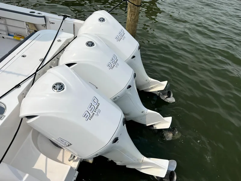 Slide: The Image of Triple Yamaha 350 outboard engines on a 2012 Everglades 350LX boat in water. - 21