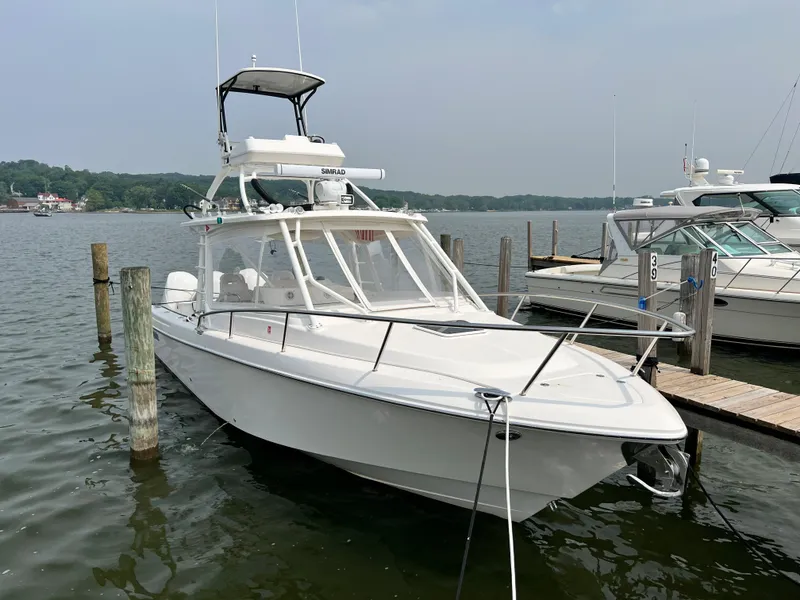 Slide: The Image of 2012 Everglades 350LX boat docked on a calm lake. - 11