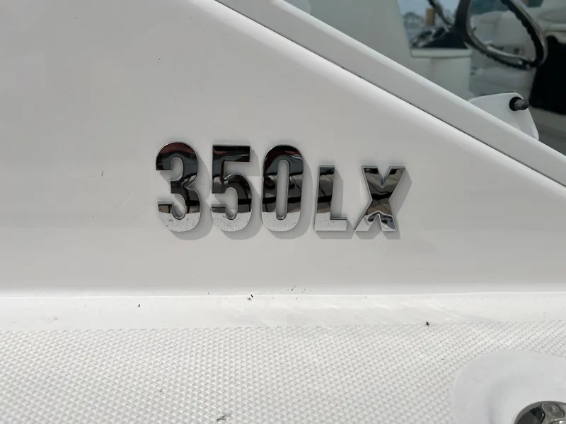 Slide: The Image of Close-up of 2012 Everglades 350LX model name on white boat surface. - 32