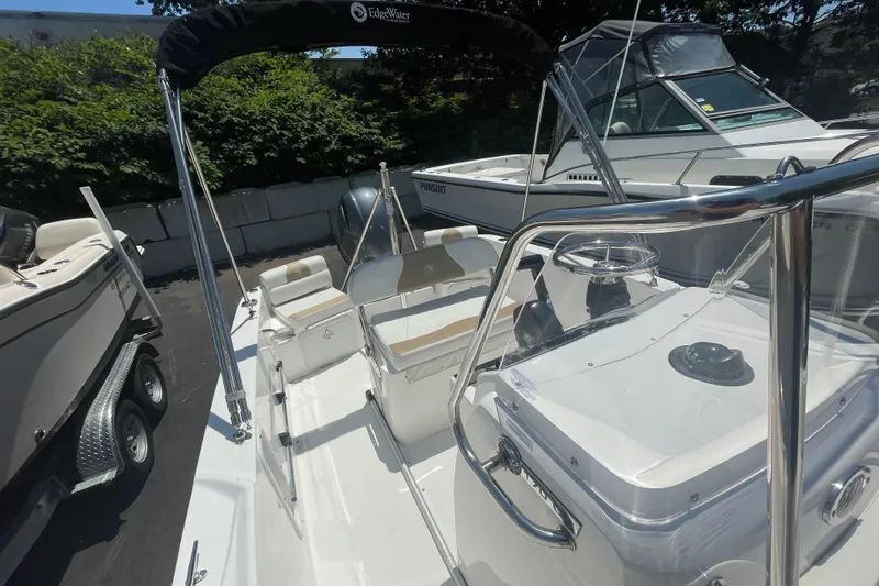 Slide: The Image of 2021 Edgewater 170CC boat interior with steering console and seating. - 11