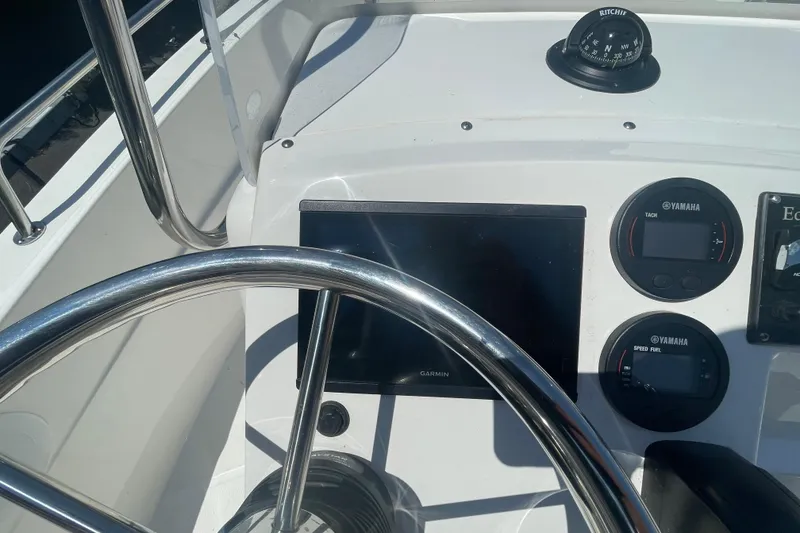 Slide: The Image of 2021 Edgewater 170CC boat dashboard with Garmin display and Yamaha gauges. - 6