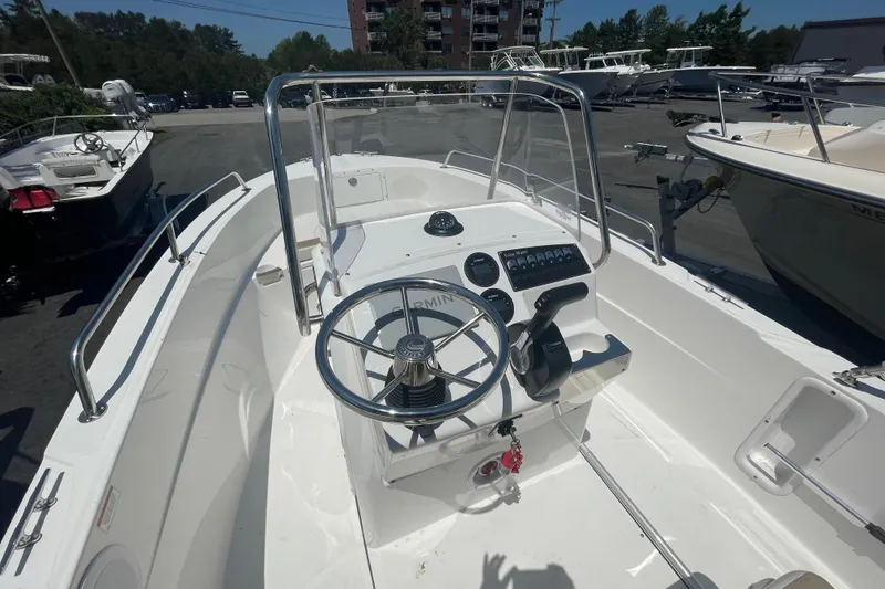Slide: The Image of 2021 Edgewater 170CC boat interior with steering wheel and control panel. - 5