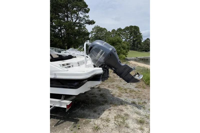 Slide: The Image of 2018 Chaparral 21 H2O Ski & Fish OB with Yamaha outboard motor, parked near a lake. - 3